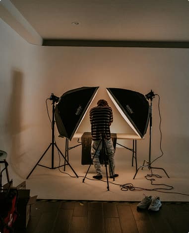 Behind the scenes studio photoshoot setup with lighting equipment