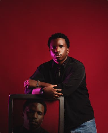 Portrait of a man in a black shirt against a red background